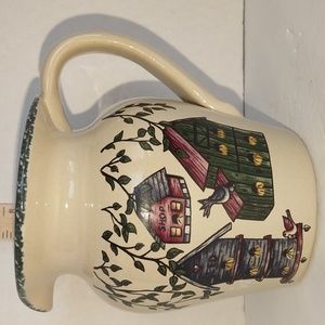 A vintage birdhouse decorated pitcher.
